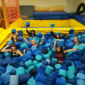 Female students in foam ball pool at Fluvium