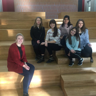 Female students sitting in the atrium of the Mira Lobe School