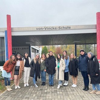 Students in front of von-Vincke-School logo