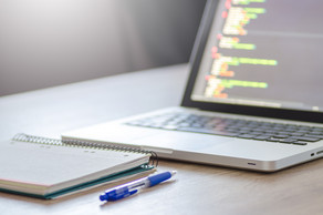 Laptop and notebook on a table